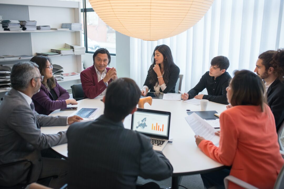 team sitting around a table discussing strategy